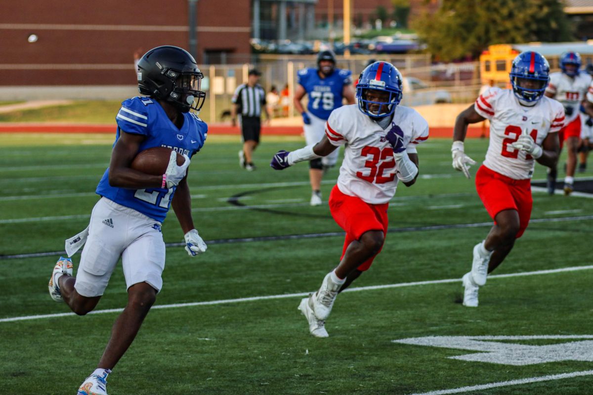 Running back Marcus Johnson runs past defenders during their scrimmage against Duncanville on Aug. 22. The team also scrimmaged Wylie East on Aug. 15 in preparation for the upcoming season. 