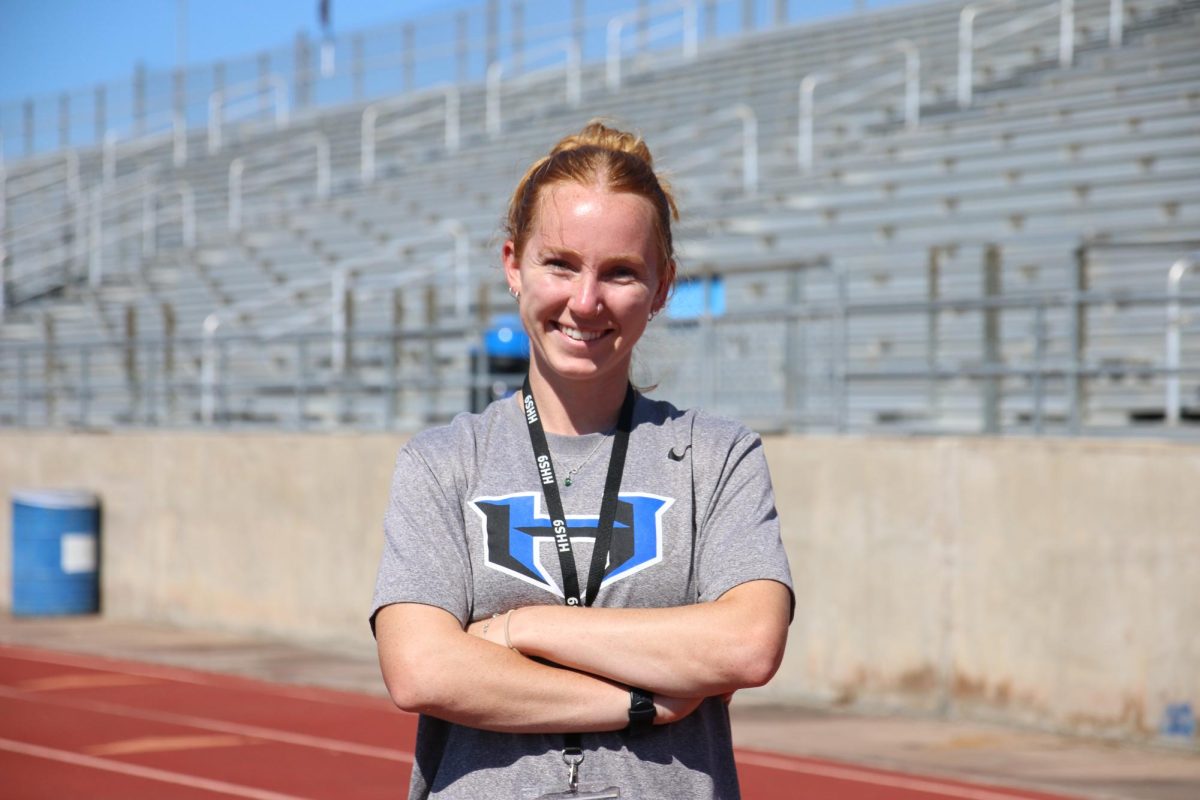 Assistant track and cross country coach Annie King on the track at Brian Brazil Stadium. King is a Hebron alumna and participated in track and cross country during her time here.