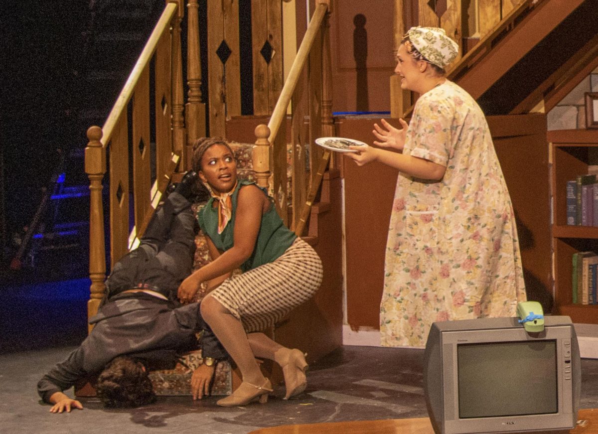 Seniors Keane Nair (left) and Maya Ware and junior Elyse Brown perform a scene where Nair falls down the stairs. The show opens on Thursday Sept. 26.