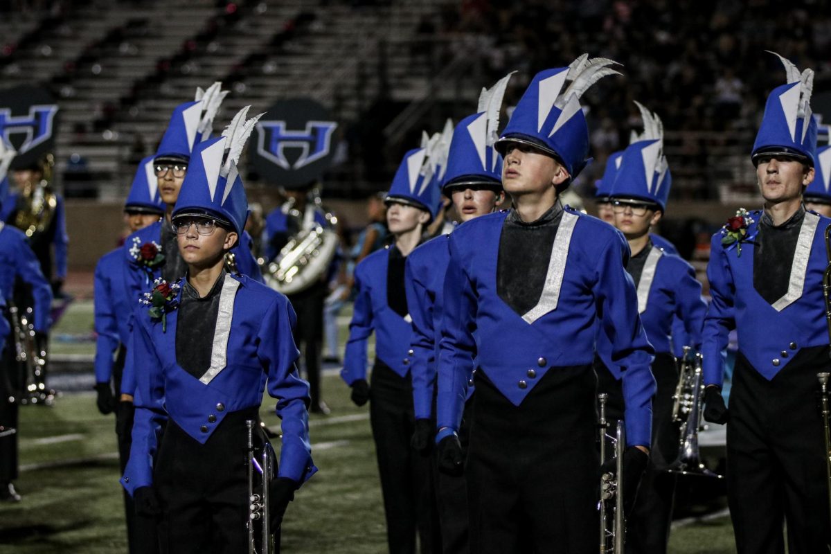 Trumpet players Madalyn Goins (left) and Judah Bessonette (right) pose after the first part of “Amorphous” at the football game against Denton Guyer. This was the second time the band performed the third movement of the show.
