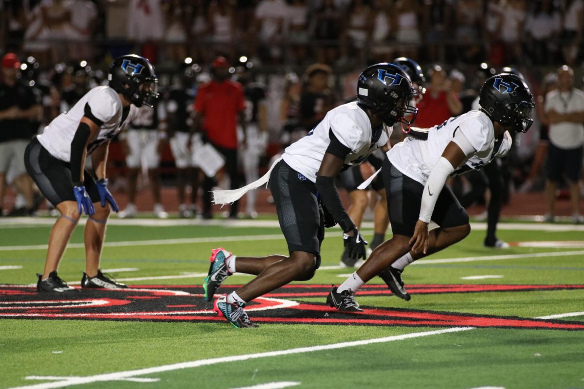 Safeties Dillion Collins and KJ Smart blitz the quarterback during the fourth quarter of the teams game against Coppell on Sept. 27. The team currently sits last place in the district standings after losing the game with a score of 49-14.