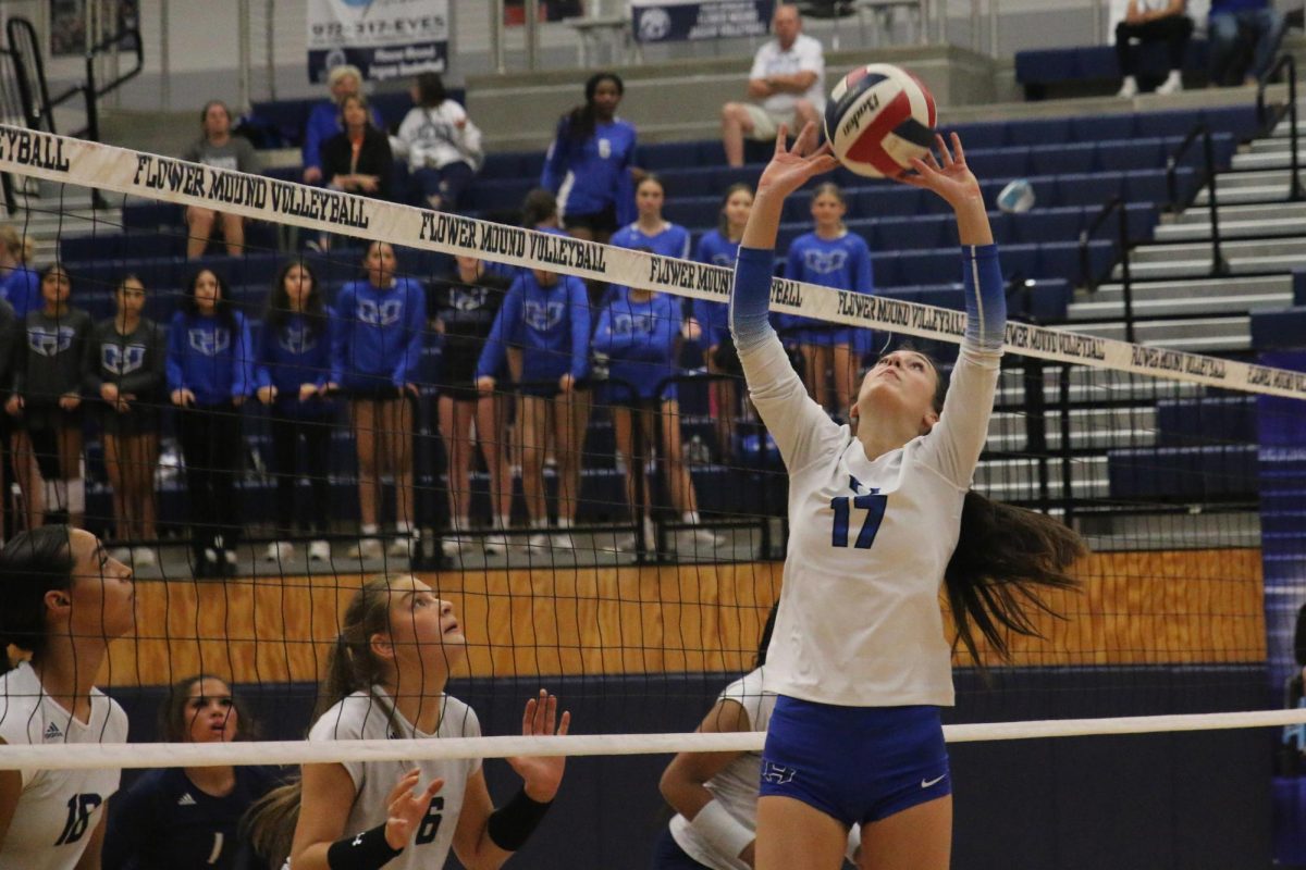 Setter Kamryn Mullican sets the ball for outside hitter Taylor Johnson in the first set. The team made the kill, gaining a 3-2 lead; they went on to lose their first set they lost throughout the entirety of the district season. 