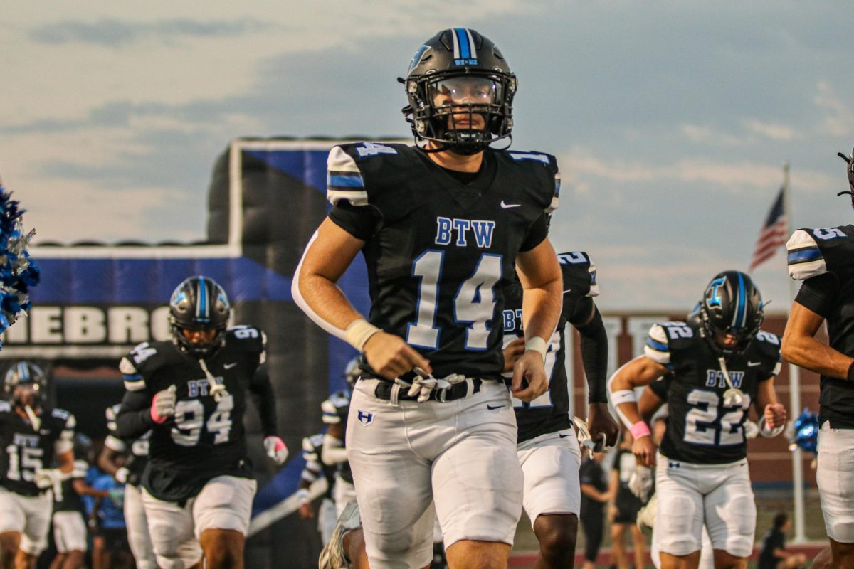 Luke runs out onto the field before the football team’s game against Guyer on Oct. 11. Luke was named as one of three players of the game. 