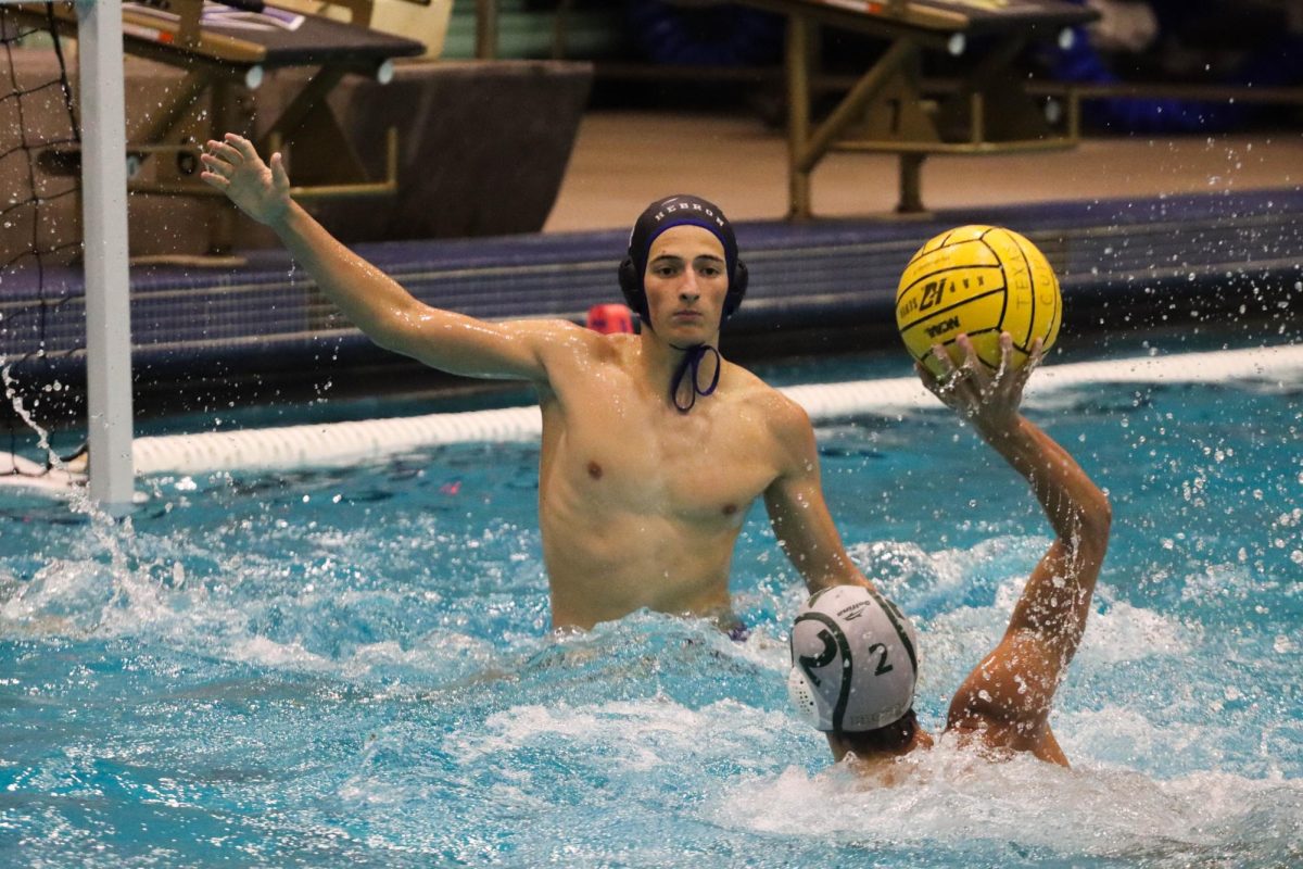 Center defender Bogdan Slavu blocks the ball from entering the goal in the team’s game against Flower Mound on Sept. 24. The boys team won 20-8 and the girls lost 17-9. 