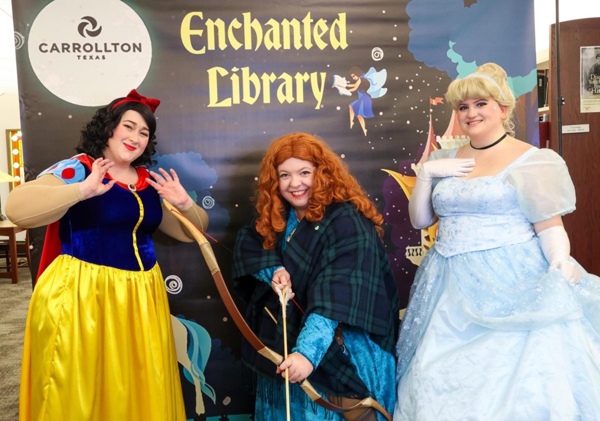 Party princesses Snow White, Merida and Cinderella pose in front of the banner for the Carrollton Public Library event “Enchanted Library” last year. The event will be held on Nov. 22 from 5-8 p.m. and is for all ages. 