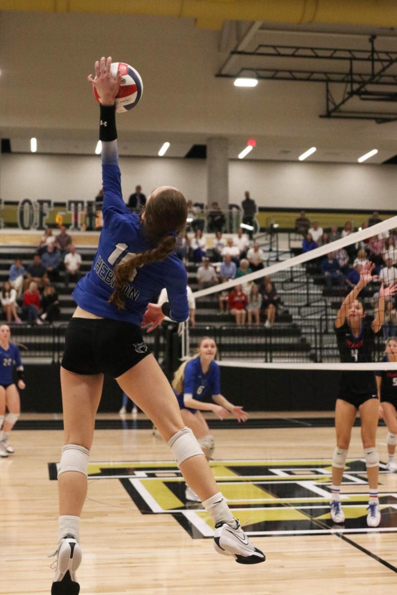 Outside hitter Cadence McDonald spikes the ball in the third set. JJ Pearce blocked the shot, resulting in the Lady Hawks losing the point and leaving them trailing 12-6 in the third set. 