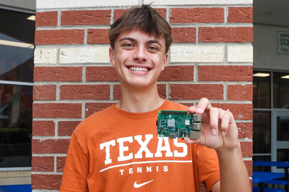 Senior Cade Moyle holds a Raspberry Pi –– a miniature computer — in his hands. He has a knack for working on computers, doing math equations and playing tennis. 