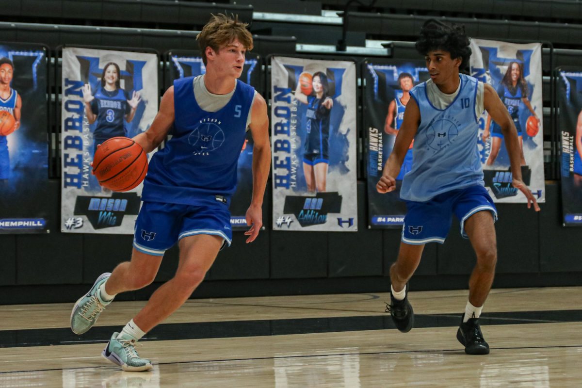 Guard Tyler Hoke drives the ball against guard Nirav Perumal during a practice on Dec. 16. The team will play its district opener against Guyer on Dec. 17.