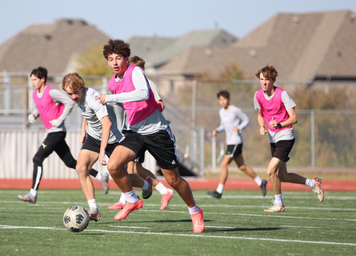 Striker Rocco Viana defends the ball from midfielder Landen Krey during practice on Dec. 3. While Krey interchanged between JV1 and varsity last year, this is his first year as an official member of the varsity team.