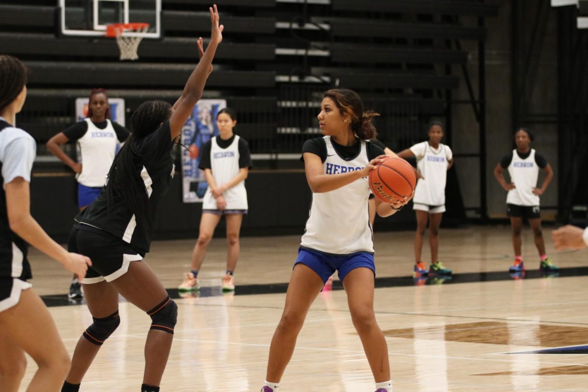 (Left to right) Guard Makayla Forde and forward Vanessa Broadnax run a practice drill with the team in practice on Dec. 6. Last year, the Lady Hawks went undefeated in district, and this year the team holds a 6-7 record upon the completion of its non-district season.