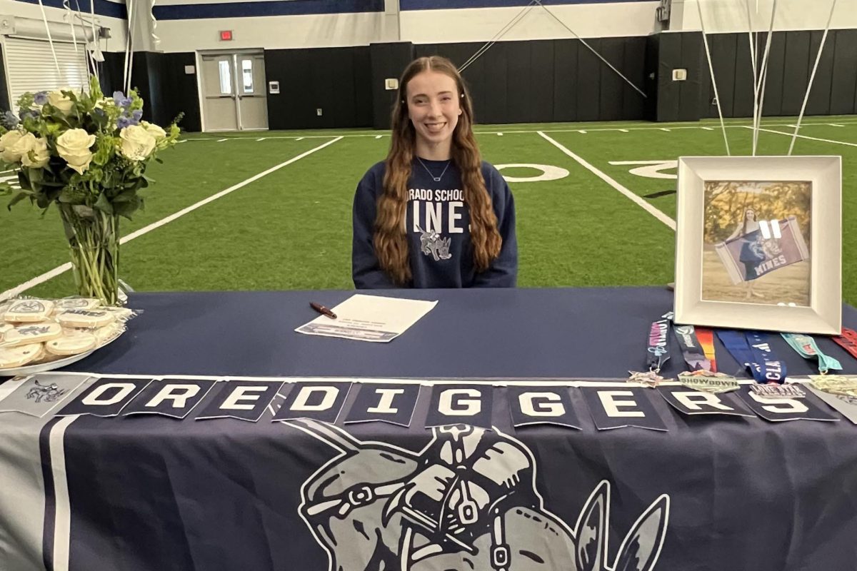 Volleyball player Cadence McDonald signs her contract during signing day on Nov. 13. She officially committed to the Colorado School of Mines following her verbal commitment on Jan. 31. (Photo provided by Cadence McDonald)