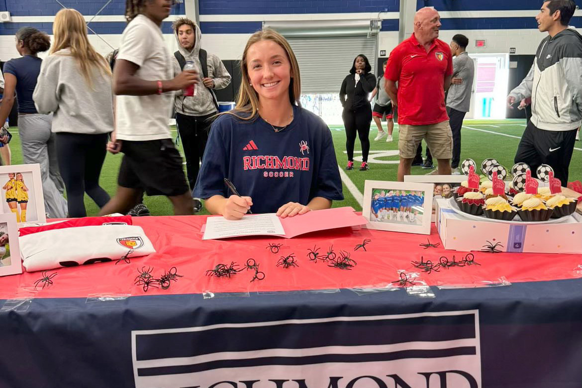 Soccer player Macray Marchione signs her contract during signing day on Nov. 13. She officially committed to the University of Richmond following her verbal commitment on June 4. (Photo provided by Macray Marchione)