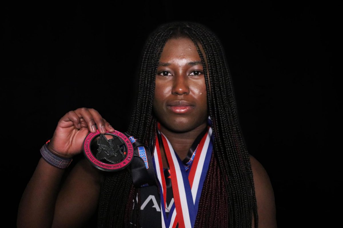 Girls wrestling captain Annalisa Afrifa holds a second place medal she won at the state championship meet her sophomore year.She wears medals she won at individual competitions. “It feels amazing to win,” Annalisa said. “It tells [me] that all my hard work hasn’t gone to waste.” 