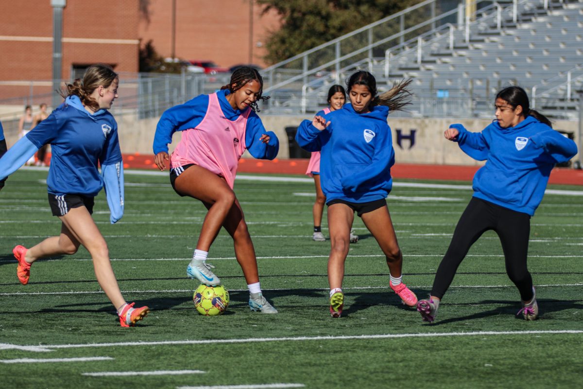 Forward Maya Walker dribbles the ball between three defenders during a practice on Jan. 17. The team will play its district opener against Coppell on Jan. 21.