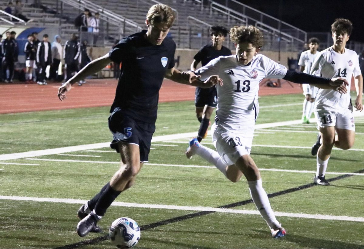 Striker Ezra Cryer dribbles past a Creekview defender at Brian Brazil Stadium on Jan. 14. The team won 3-0.