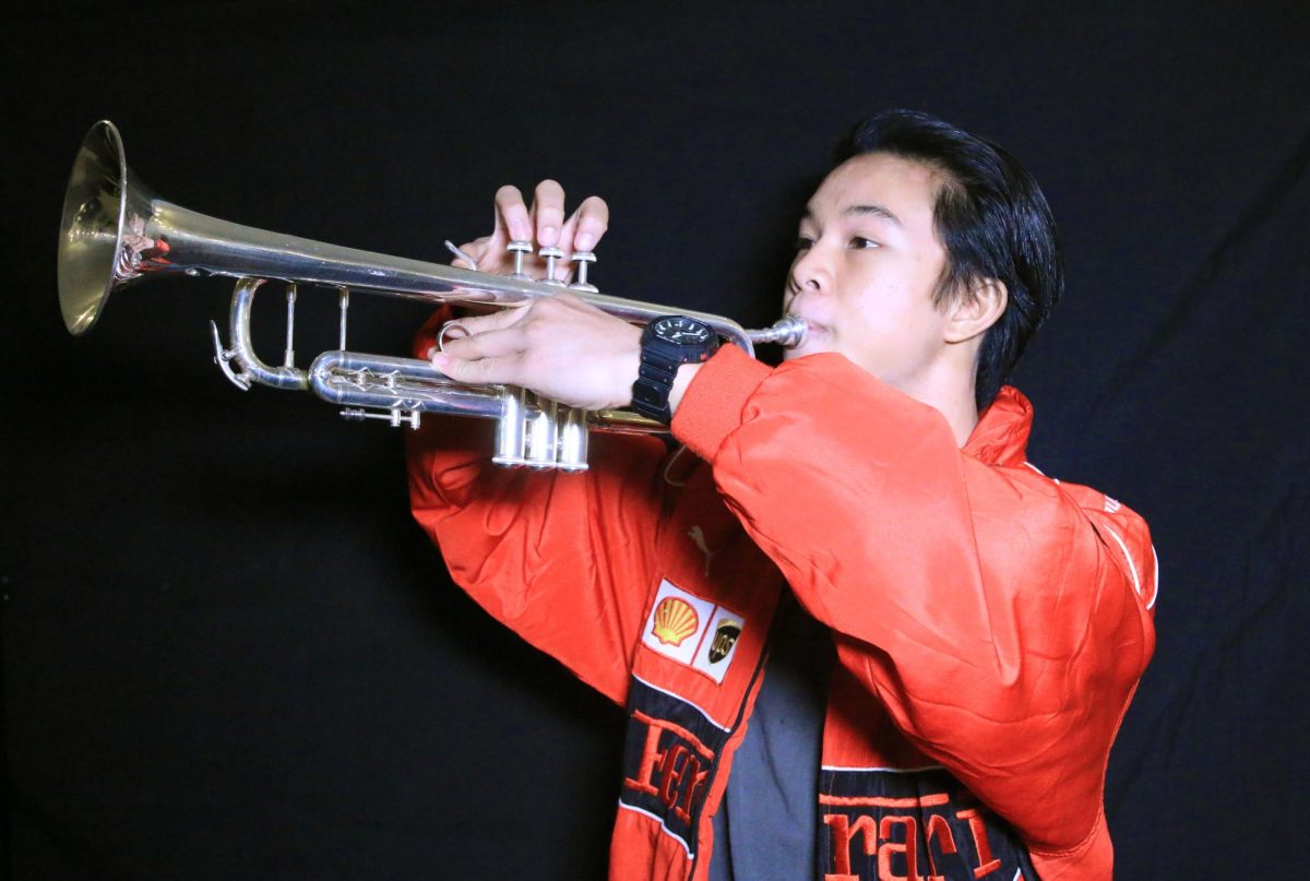 Senior Chris Bertulfo poses with his trumpet. He has played the trumpet since he was in sixth grade.